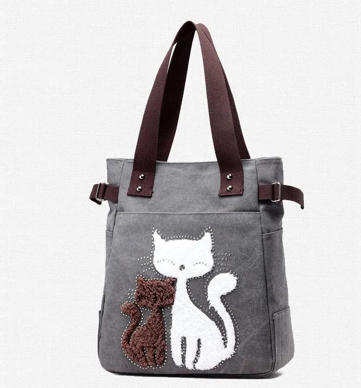 KVKY women canvas bag with plush cat applique in beige, showing shoulder strap and front pocket