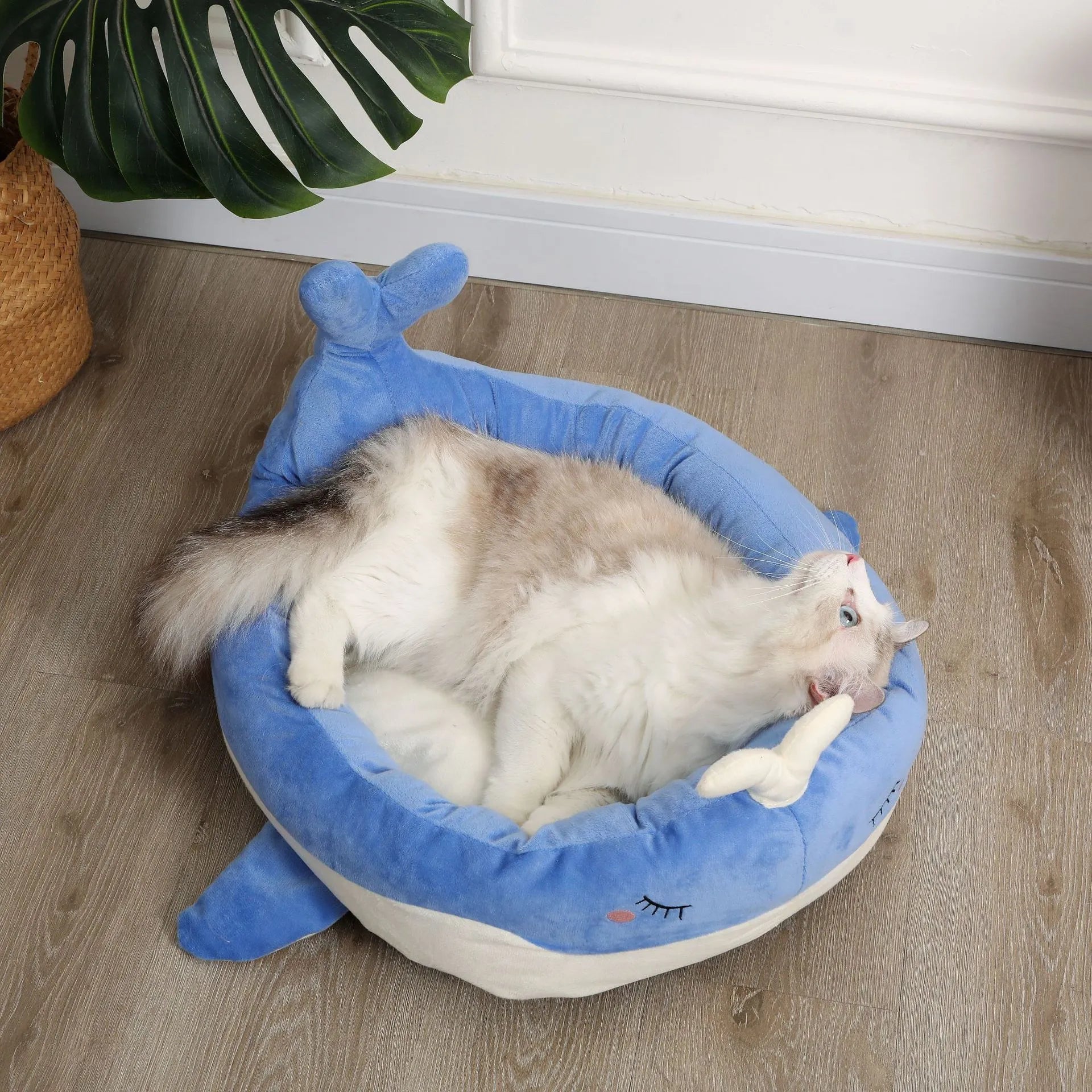Blue duck-shaped fluffy pet bed for a small dog, showing raised rim and soft material.
