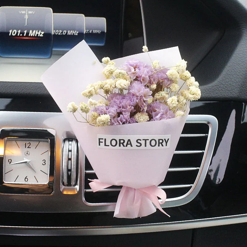 Mini dried flower bouquet clipped onto a car air vent, showing pink and white floral style.