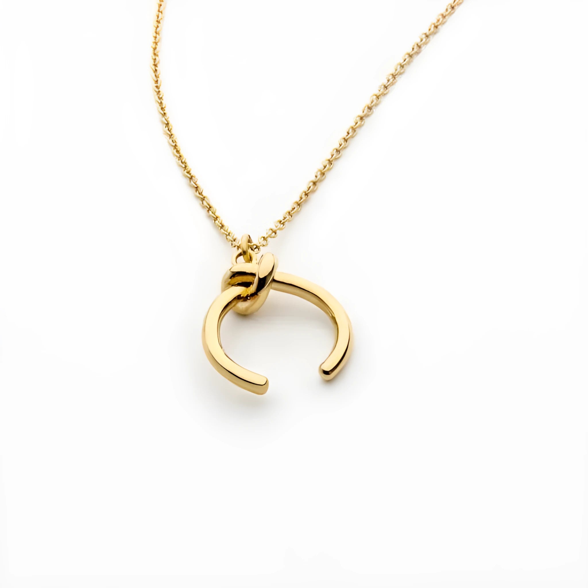 A vintage-style geometric pendant necklace with a cross chain, shown in gold and silver finishes.