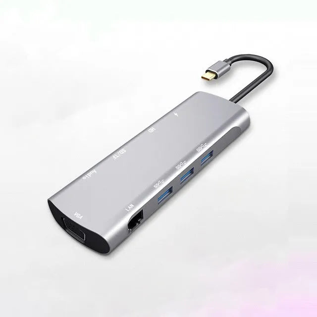 Grey aluminium USB-C docking station with 4K HDMI, VGA, and USB ports, showing 140mm attached cable.