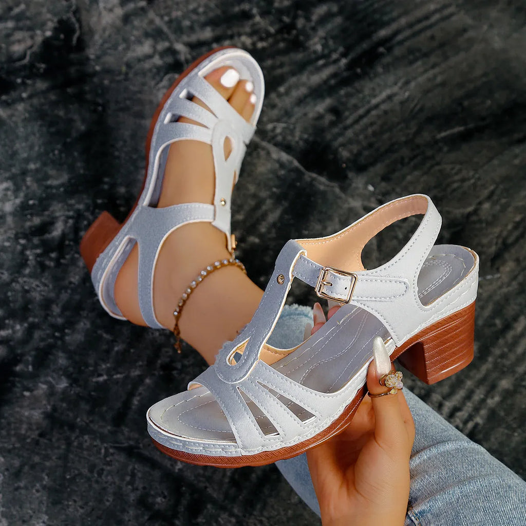 Women's black peep toe wedge platform sandals with a buckle fastening on a grey background