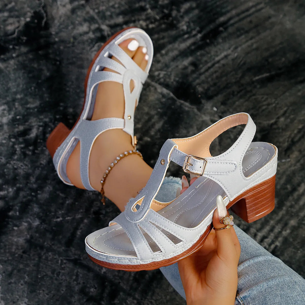 Women's black peep toe wedge platform sandals with a buckle fastening on a grey background
