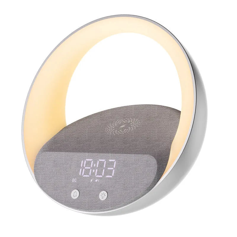 Beige multifunctional Bluetooth speaker with wireless charging surface and ambient LED lighting on bedside table
