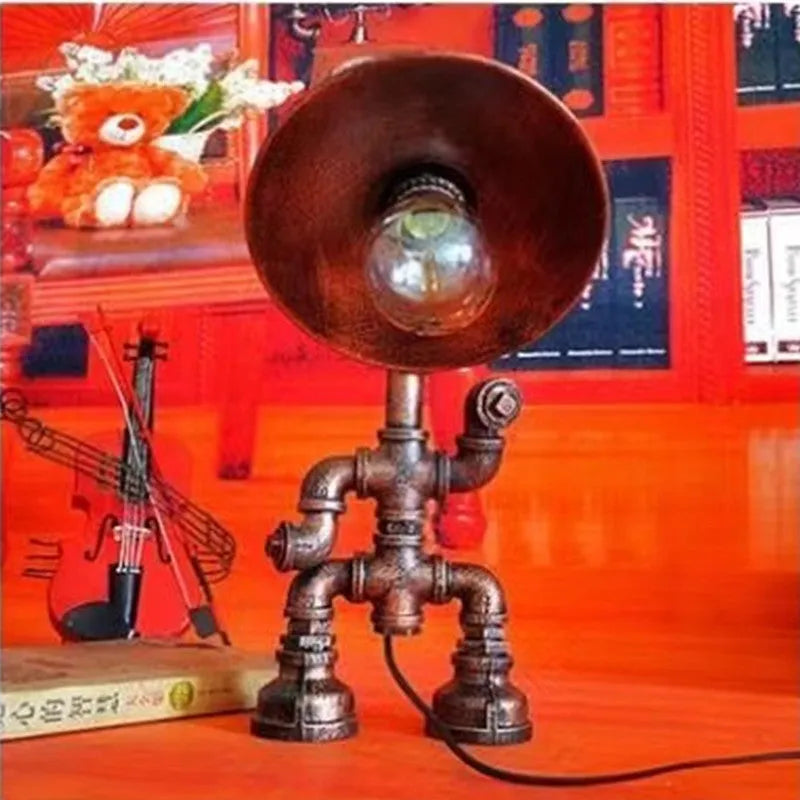 Industrial retro style water pipe robot table lamp made of iron in a vintage colour.