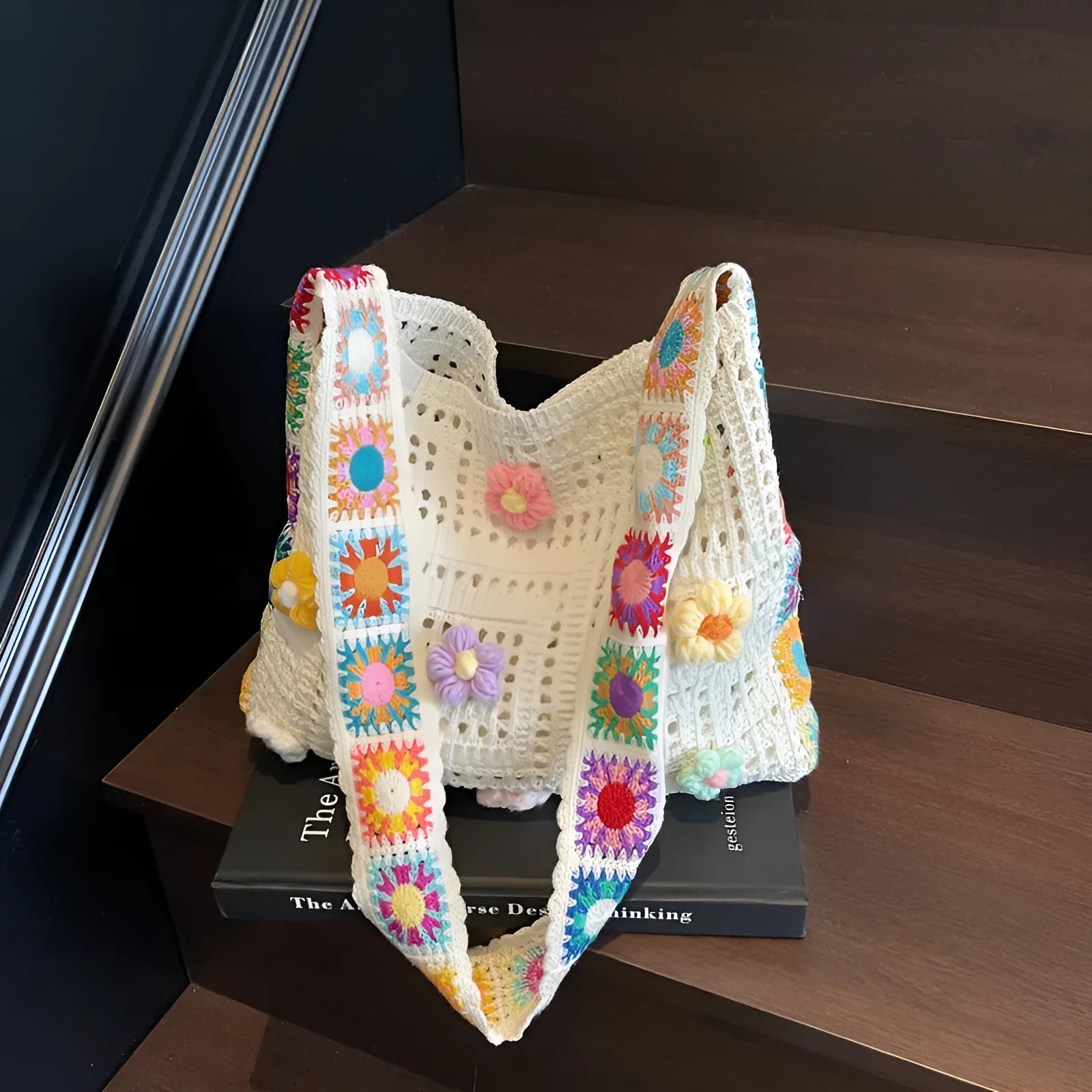 Women's casual white woven hollow beach bag with single shoulder strap on a sandy beach.