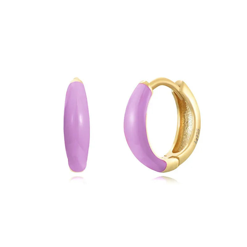 A pair of curved U-shaped epoxy earrings with a translucent blue dripped oil finish and a silver hook on a white background.