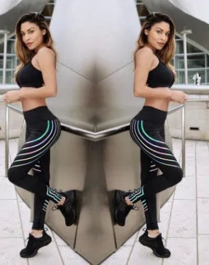 Women's black workout leggings with glowing white print pattern, showing slimming pencil pants fit.