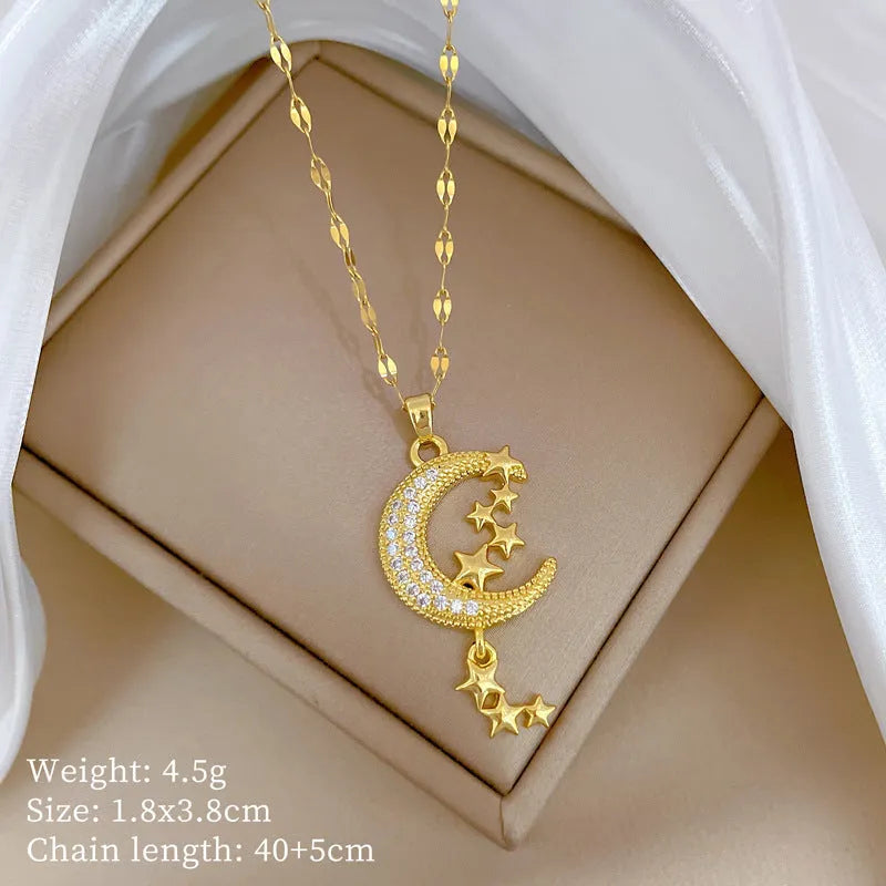 Moon tassel necklace with full diamond geometric pendant on a stainless steel chain, showing tassel detail.