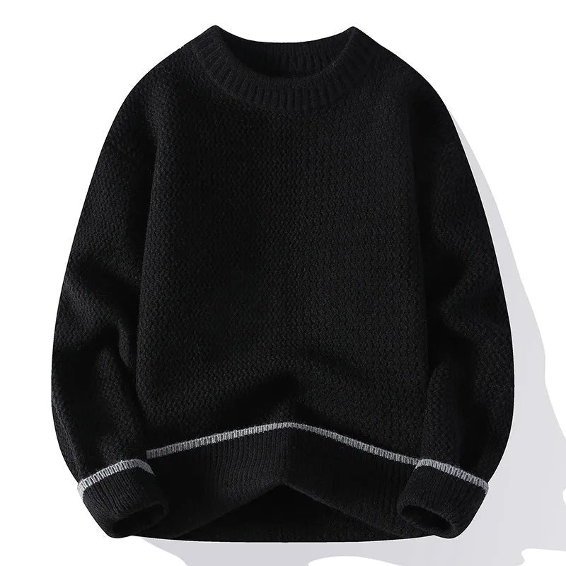 Man wearing a grey loose-fit round neck long sleeve pullover sweater.