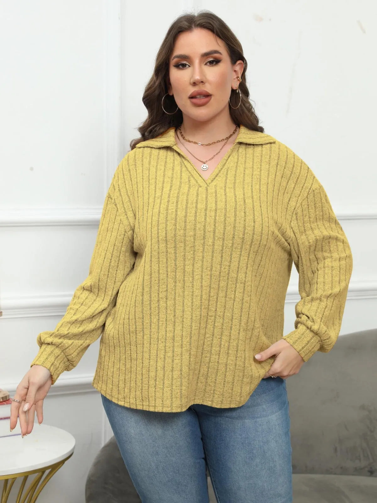 Women's plus size grey polo collar fleece shirt with lantern sleeves laid flat.