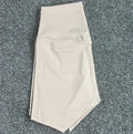 High-waisted women's yoga shorts in nylon fabric, shown in a selection of colours including pink litchi and cayenne red.