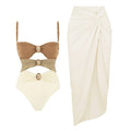 Women's solid-colour one-piece swimsuit with gold buttons and a matching skirt in assorted colours.