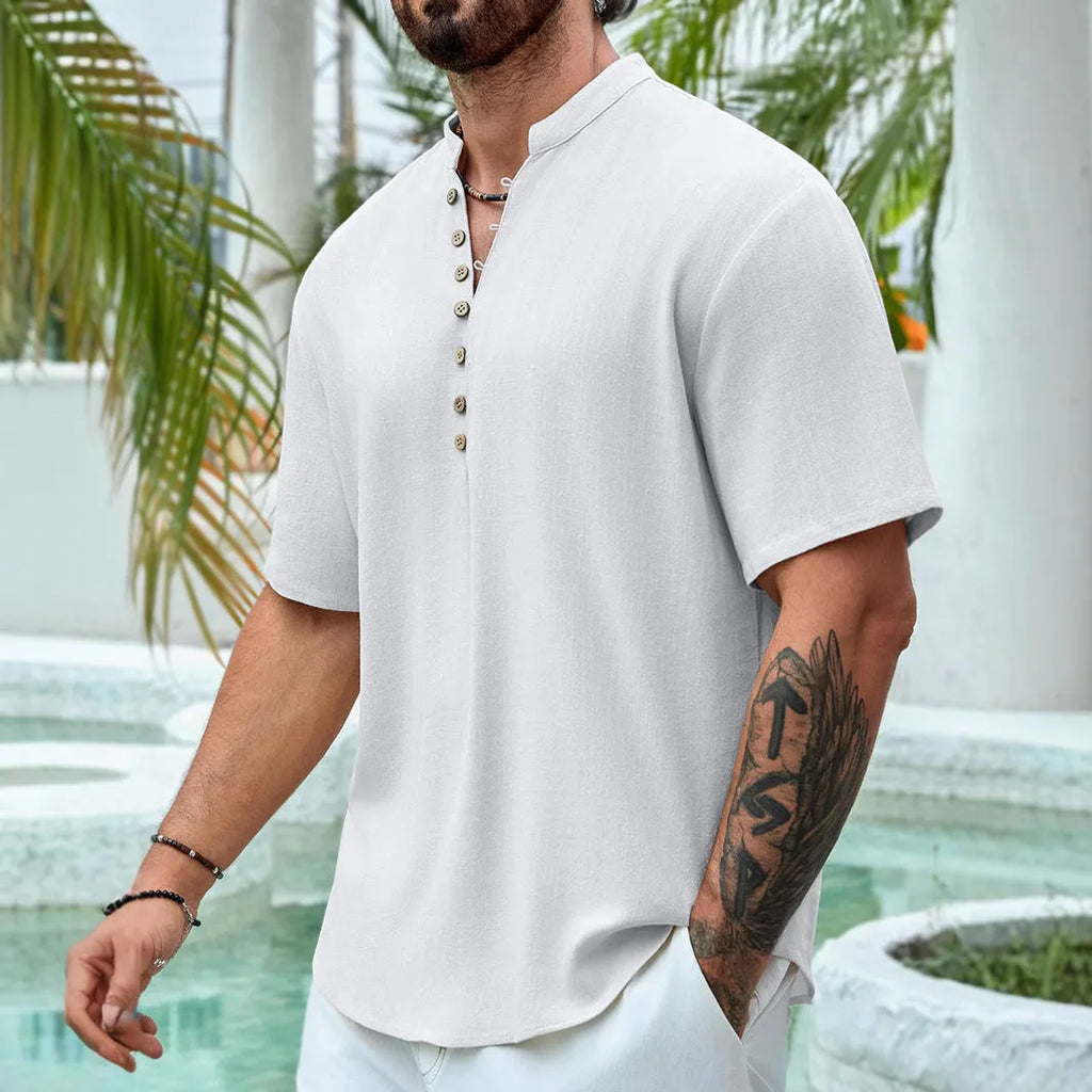 Man wearing a deep V-neck multi-button short sleeve casual shirt in a solid colour.
