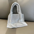 Silver cotton thread evening handbag with shiny rhinestone detailing and open outer pocket