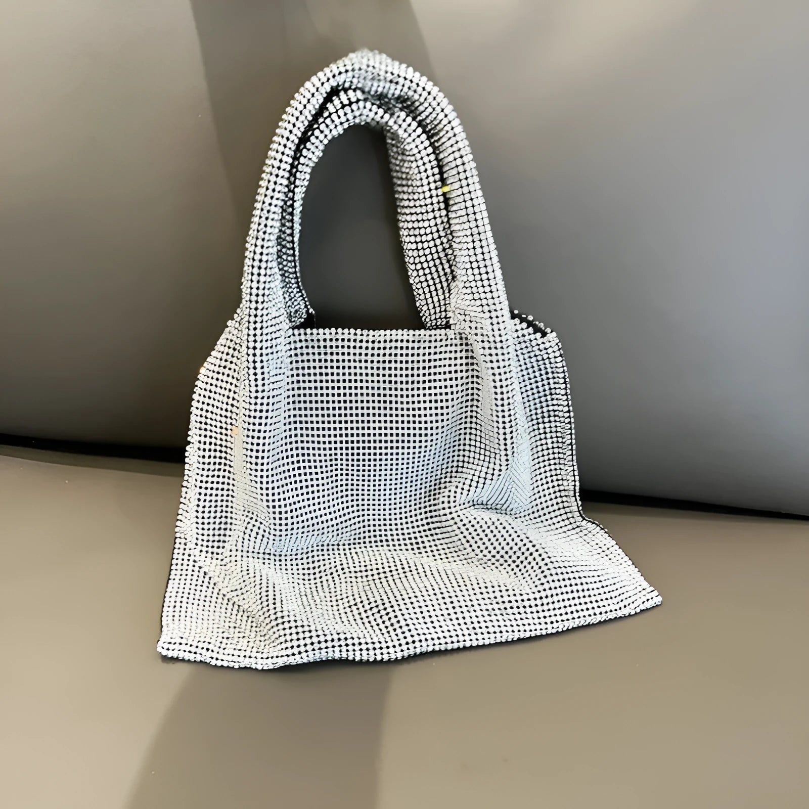 Silver cotton thread evening handbag with shiny rhinestone detailing and open outer pocket
