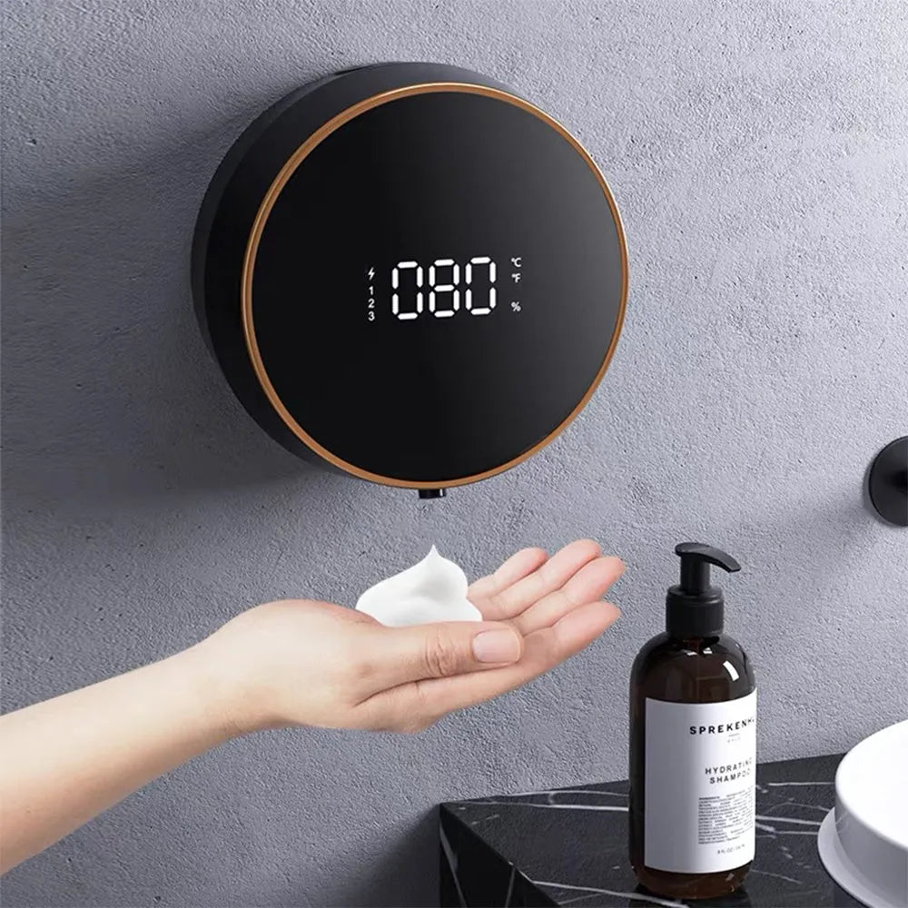 Black and white automatic sensor foam soap dispenser mounted on a wall with USB charging cable.