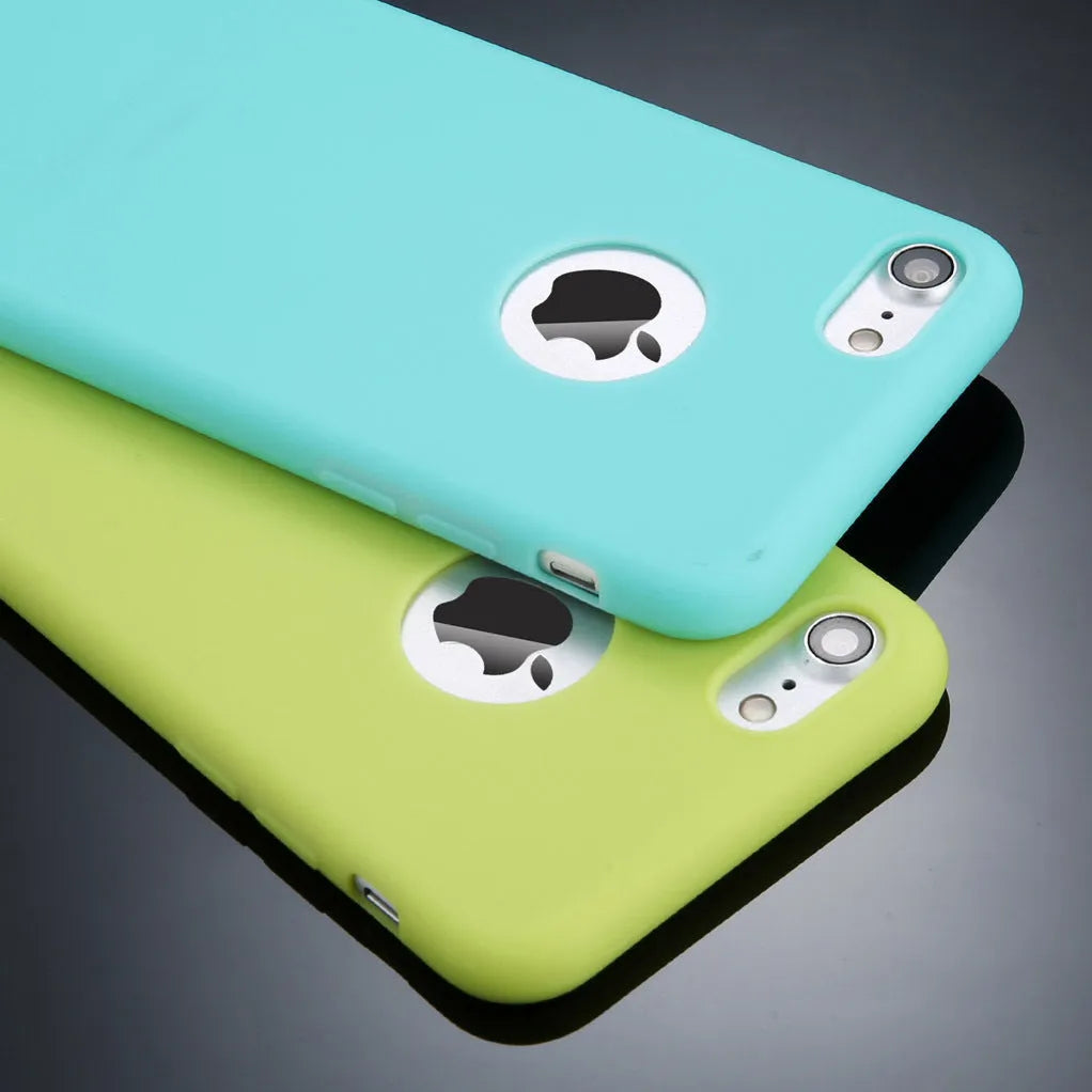Soft plain silicone TPU phone case for iPhone in candy colours like pink, blue, and green on a table.