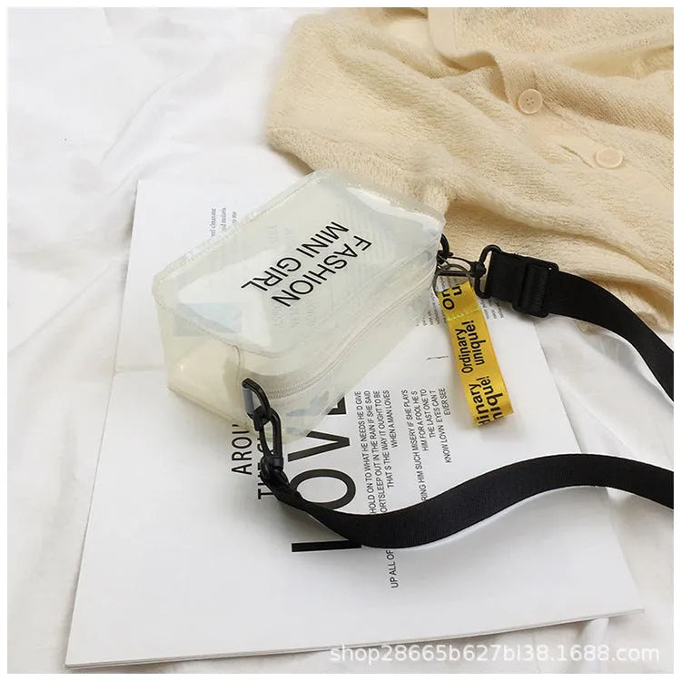 Transparent square jelly shoulder bag in PC material with an adjustable strap, shown in a light colour.