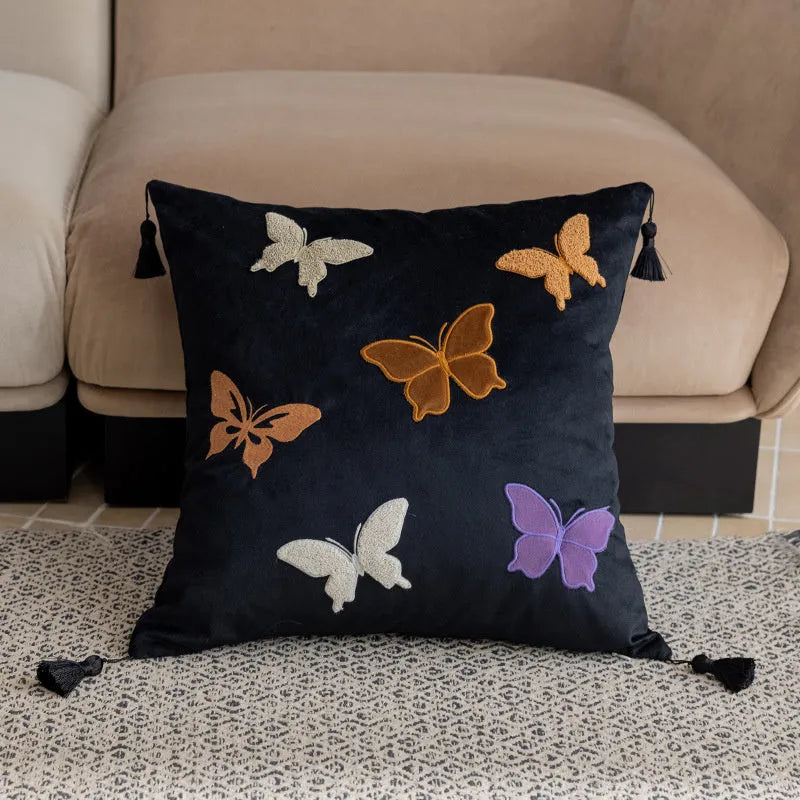 Square beige cushion with embroidered black butterfly pattern in Chinese style.