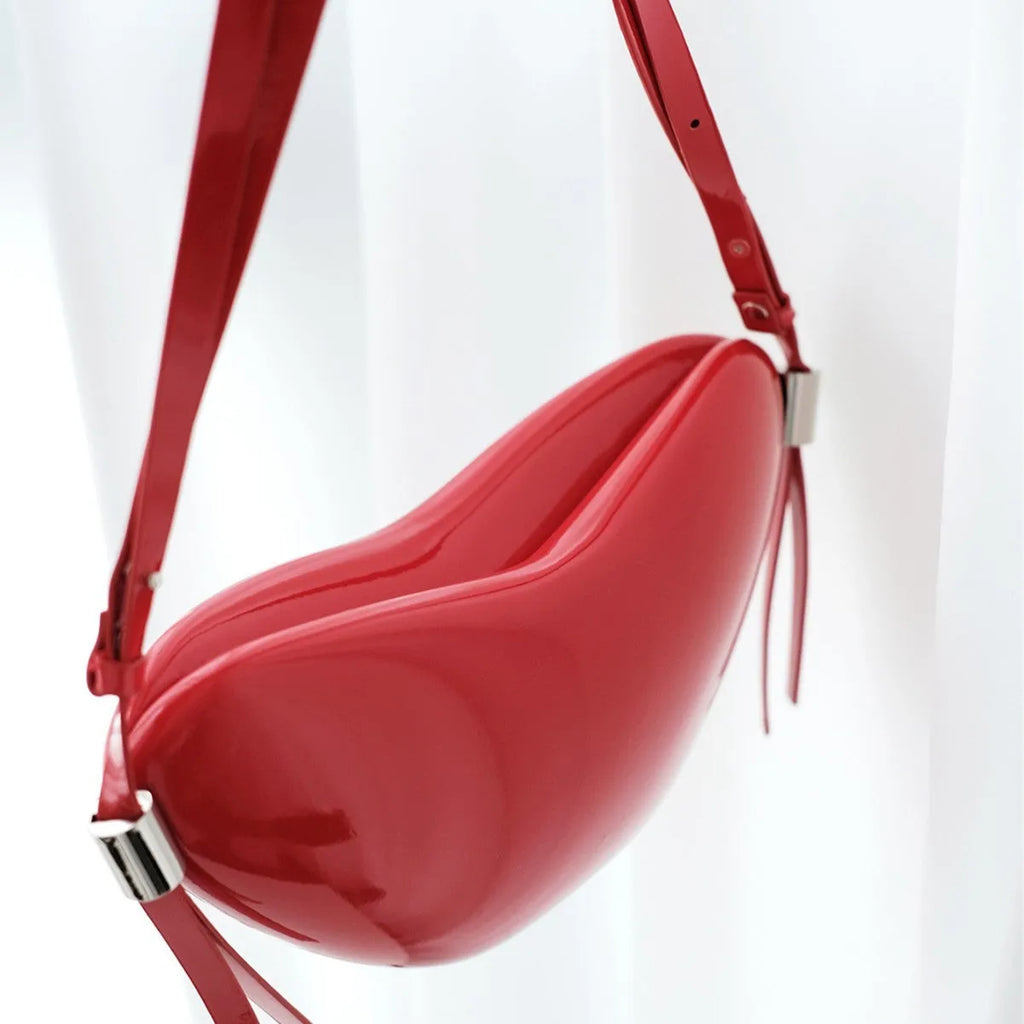 Red PU heart crossbody bag with single shoulder strap and sandwich pocket