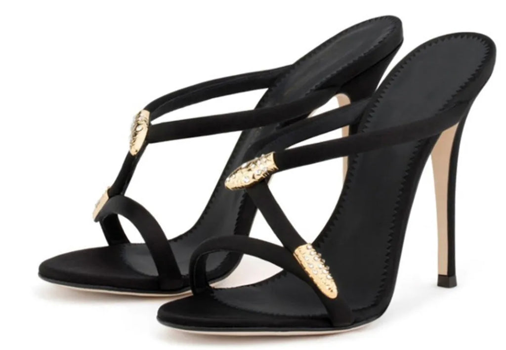 Black satin stiletto sandals with 9cm heel and decorative buckle shown on a white background