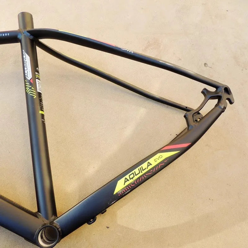 Black green aluminium mountain bike frame for 29-inch wheels with internal cable routing and disc brake mount.
