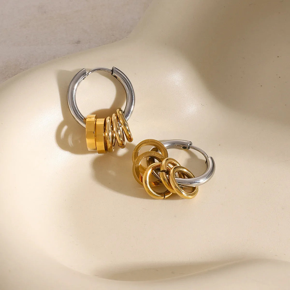 A pair of modern stainless steel earrings with an electroplated colour finish in a unisex ins style.