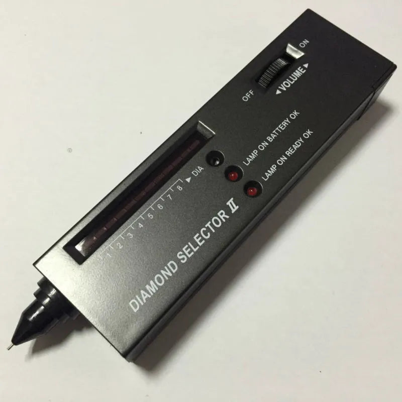 Black handheld diamond thermal conductivity meter with metal probe on a white background.