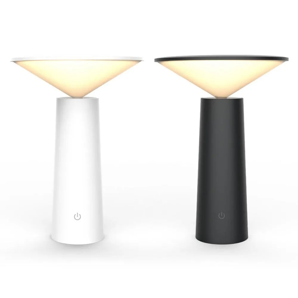 Black USB rechargeable desk lamp with touch sensor base and a tilted lamp head on a wooden desk.
