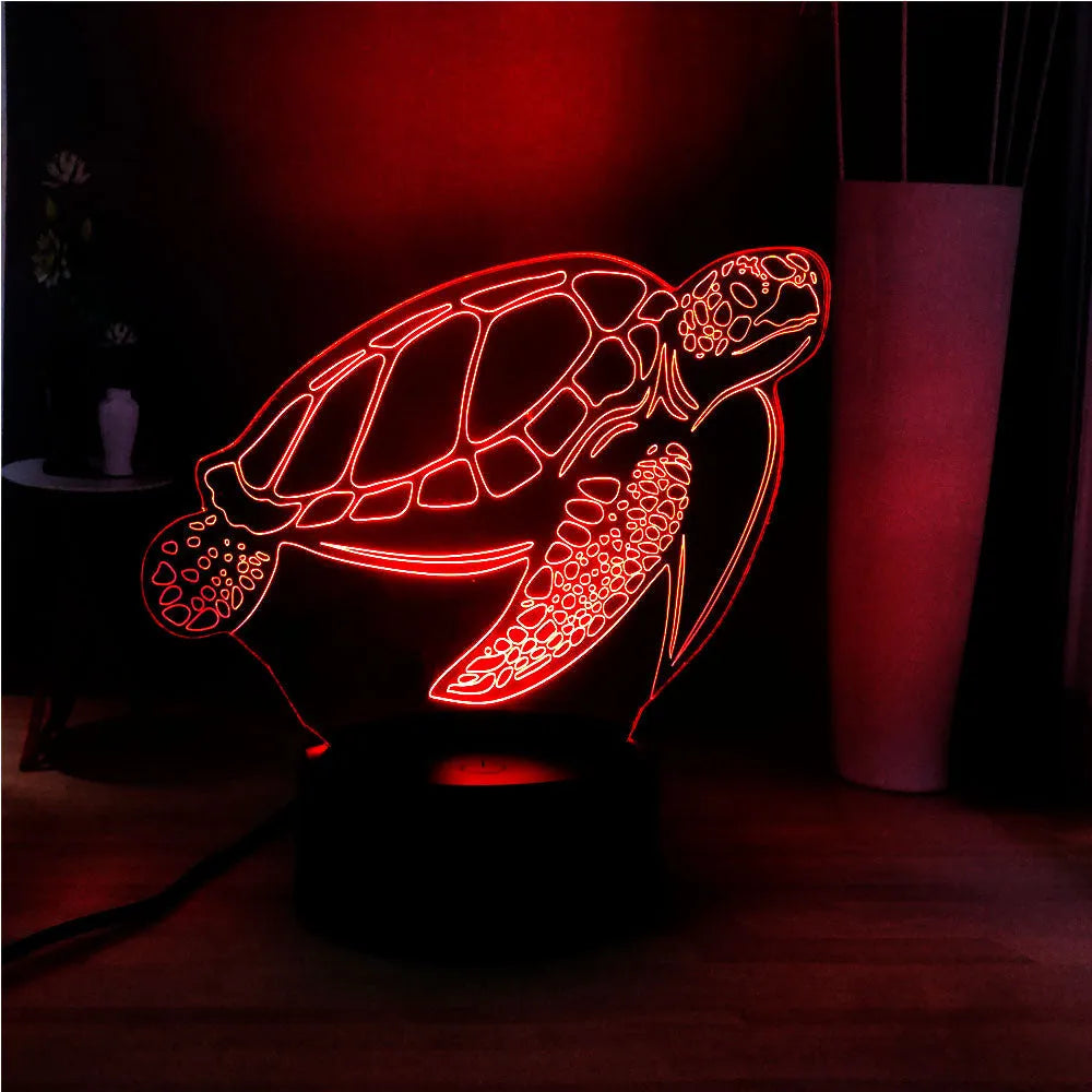 3D acrylic turtle-shaped LED night light with remote control on a bedside table.