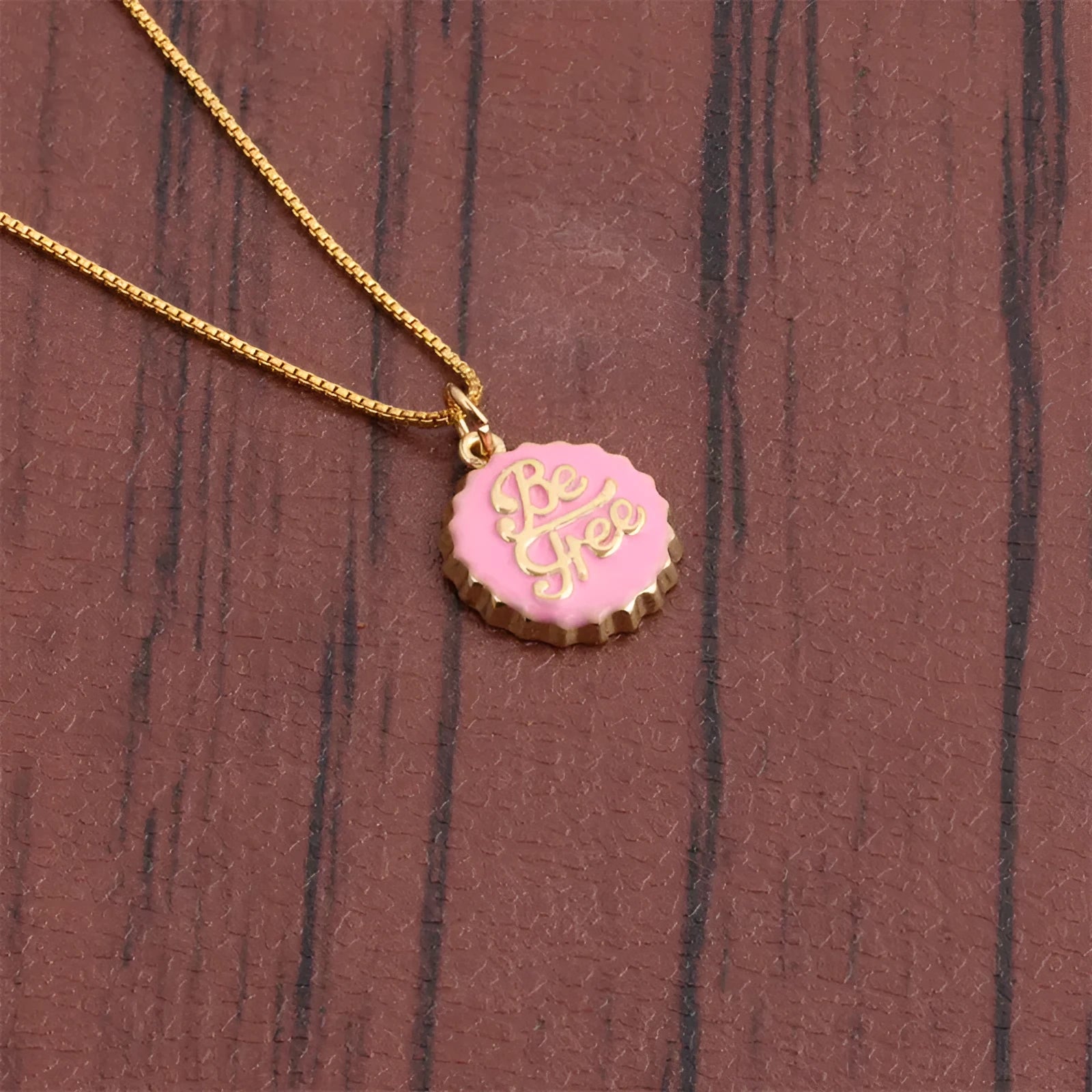 Copper bottle cap pendant necklace on a 40cm box chain with an 18K gold electroplated finish.
