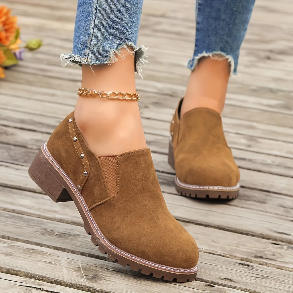 Women's light brown suede ankle boots with a low block heel and elasticated ankle cuff.
