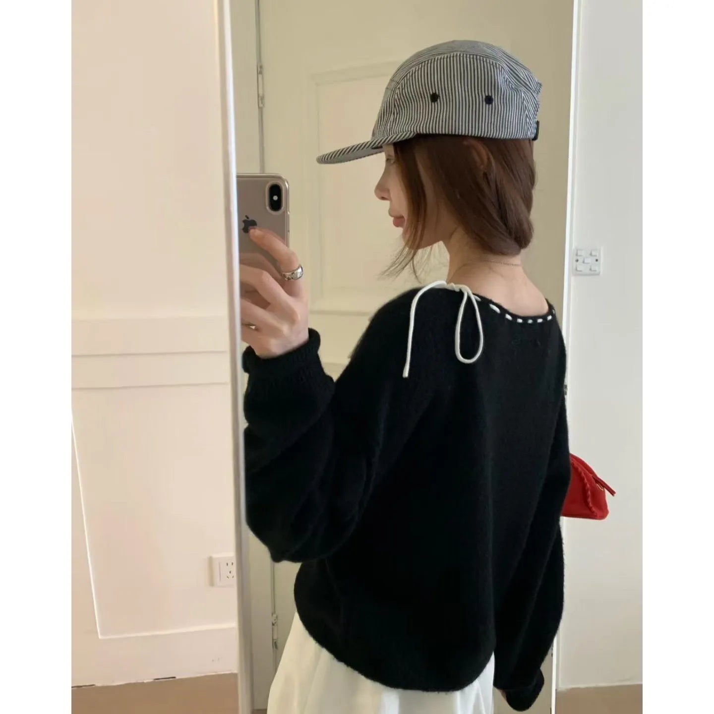 Grey loose-fitting women's pullover jumper on a hanger.