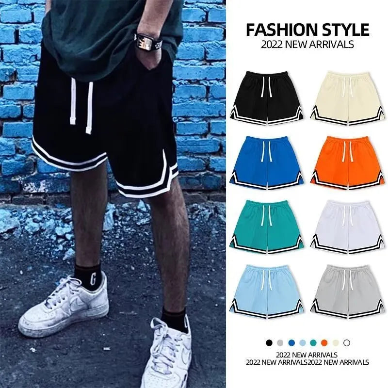 Man wearing loose-fit grey polyester sports shorts with an elastic waistband.