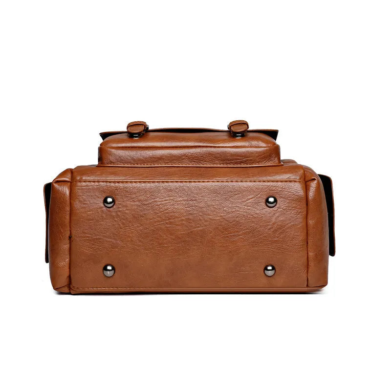 Large vintage-style messenger bag in a horizontal square shape, showing stitching detail, displayed in multiple colour options.