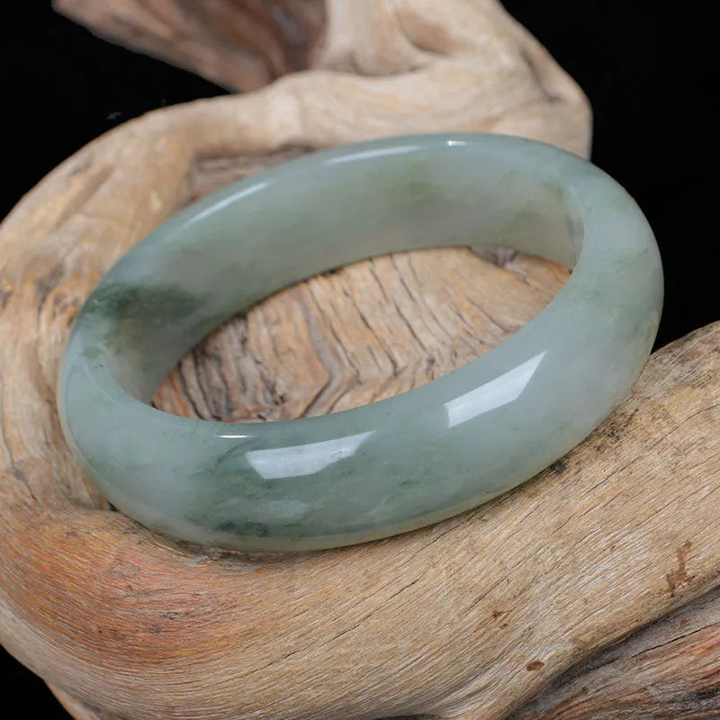Natural Jinsi Jade Chinese style bangle bracelet on a plain background.