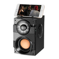 Black portable mini home audio system with subwoofer, cable, and USB power connection.