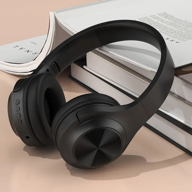 A creative head-mounted wireless Bluetooth headset in youth green colour with its matching charging case.