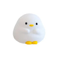 Cute duck-shaped silicone LED night lamp with touch sensor and warm glow on a bedside table