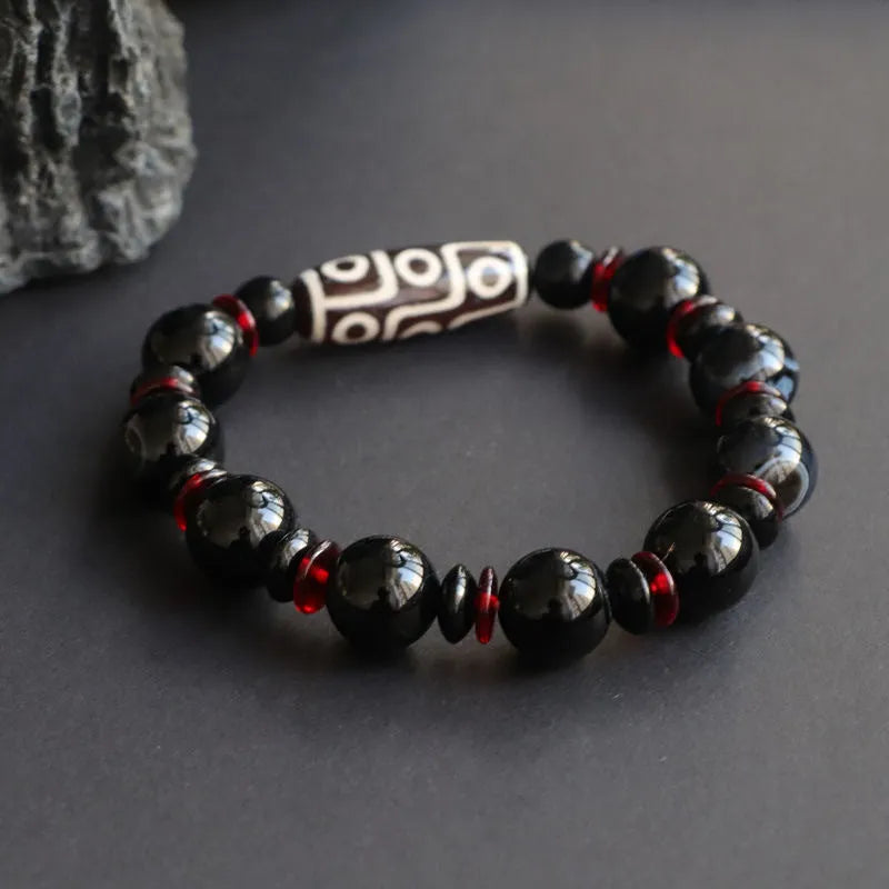 Black agate Dzi bead bracelet with hand-woven construction and 11mm geometric beads