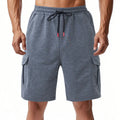Light grey loose-fit cargo shorts made from soft terry fabric, showing multiple pockets.