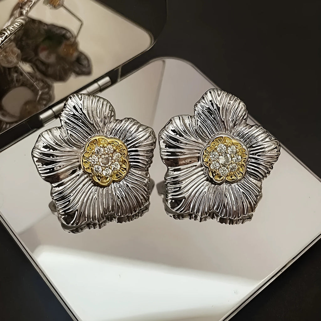 Retro copper stud earrings with a textured gardenia design in a two-tone electroplated finish.