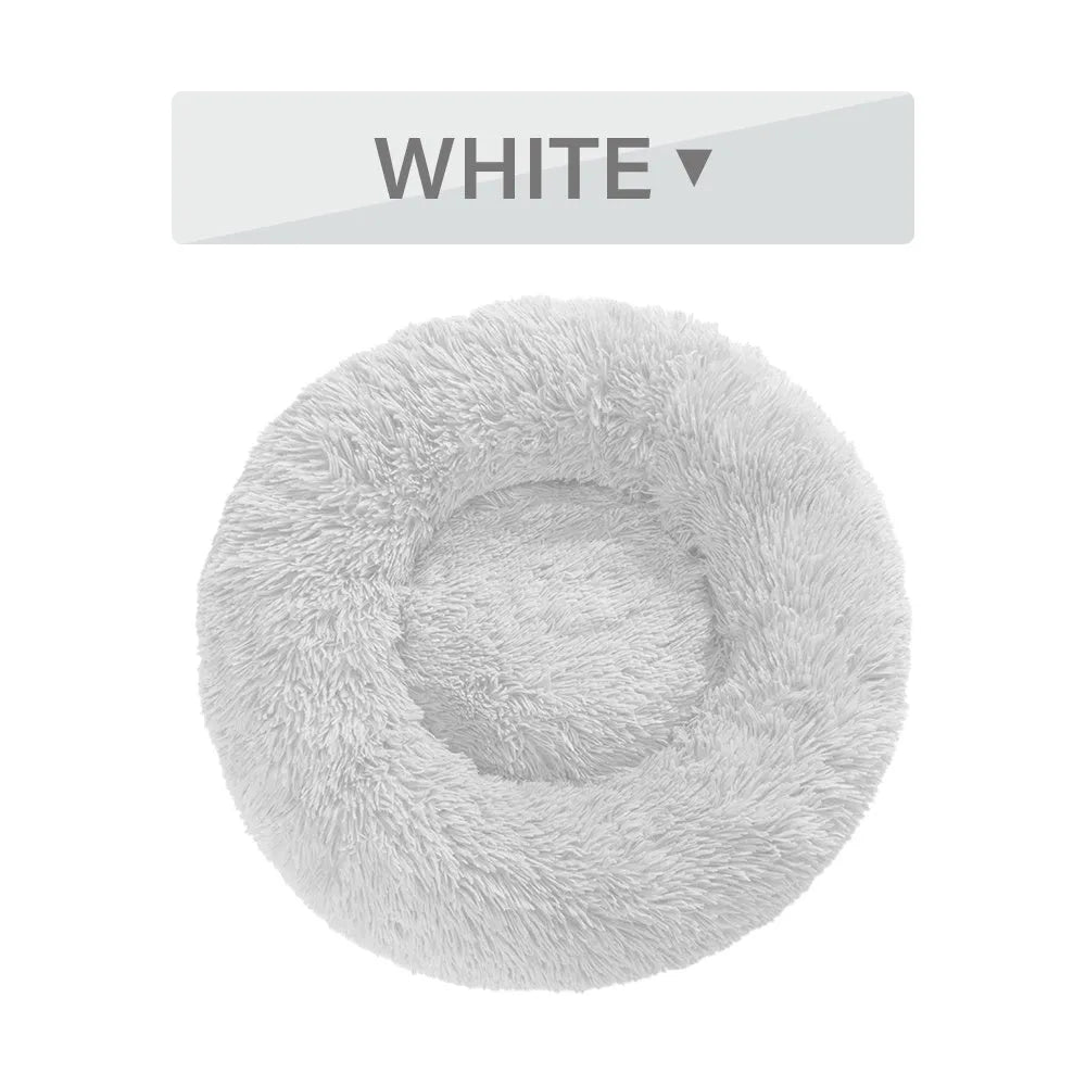 Fluffy donut-shaped pet bed in long plush fabric, showing raised rim, available in multiple colours.