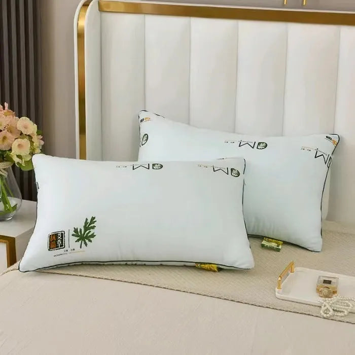 A white chemical fibre bedding pillow with a polyester shell, shown next to a blue argy wormwood patterned variant.