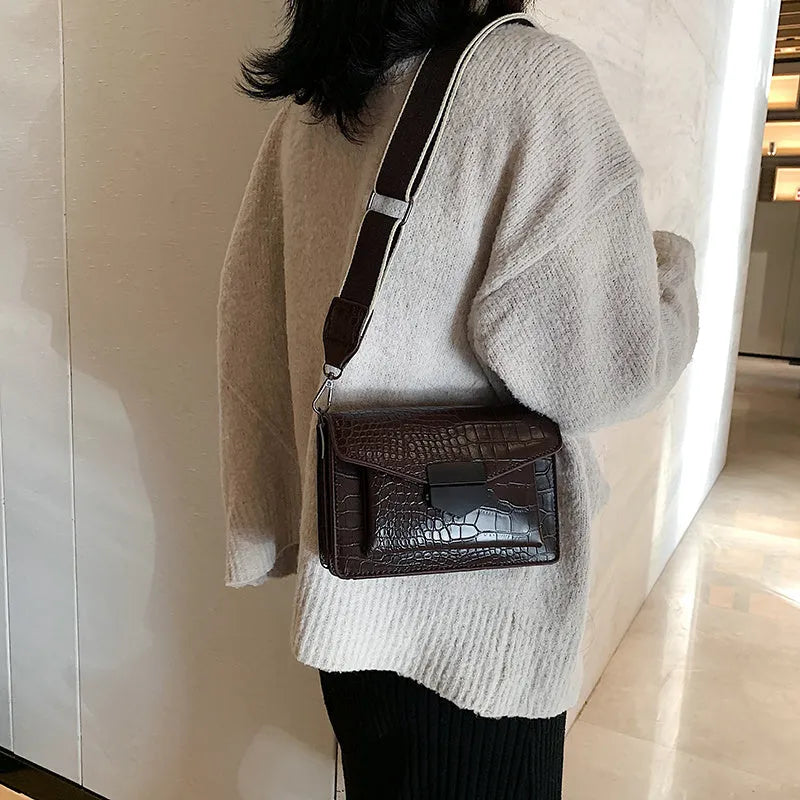 A PU fabric crossbody bag with an adjustable strap, shown in dark brown colour.