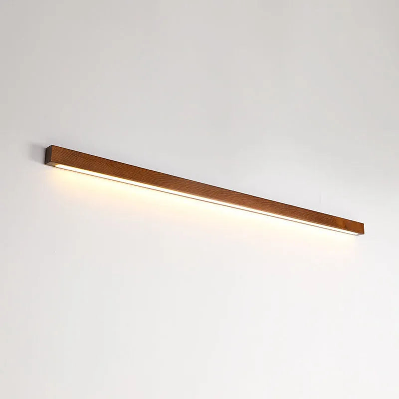 Walnut-coloured wooden log strip wall lamp with acrylic elements and integrated LED lighting.