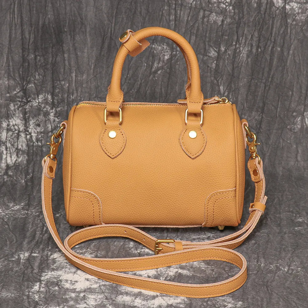 Brown handmade cowhide leather Boston bag with cylindrical shape and single shoulder strap