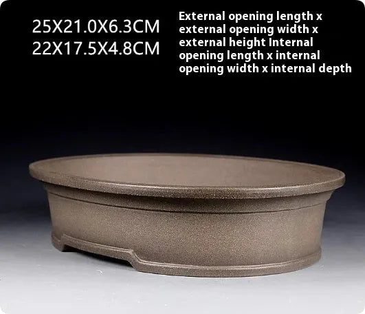 Handmade oval purple sand ceramic bonsai flower pot measuring 25 by 21 by 6.3 centimetres.