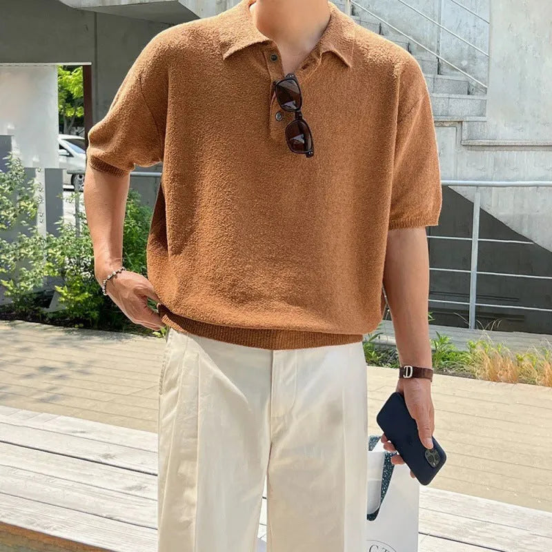 Man modelling a caramel-coloured retro asymmetric knitted polo shirt with short sleeves.
